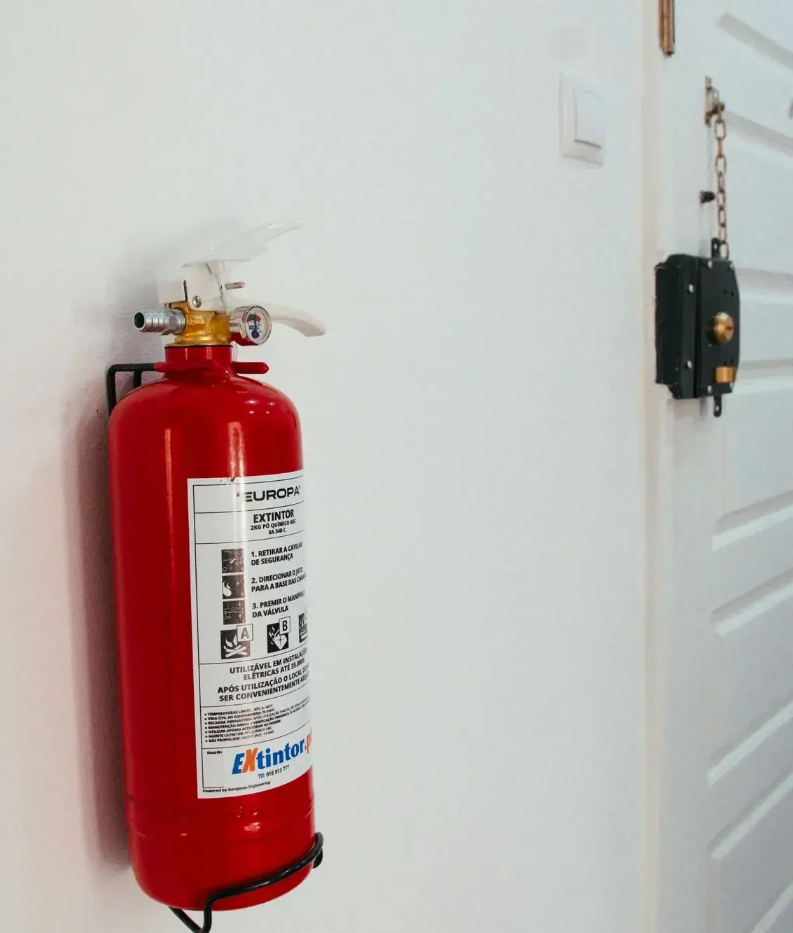 Fire extinguisher beside an apartment door